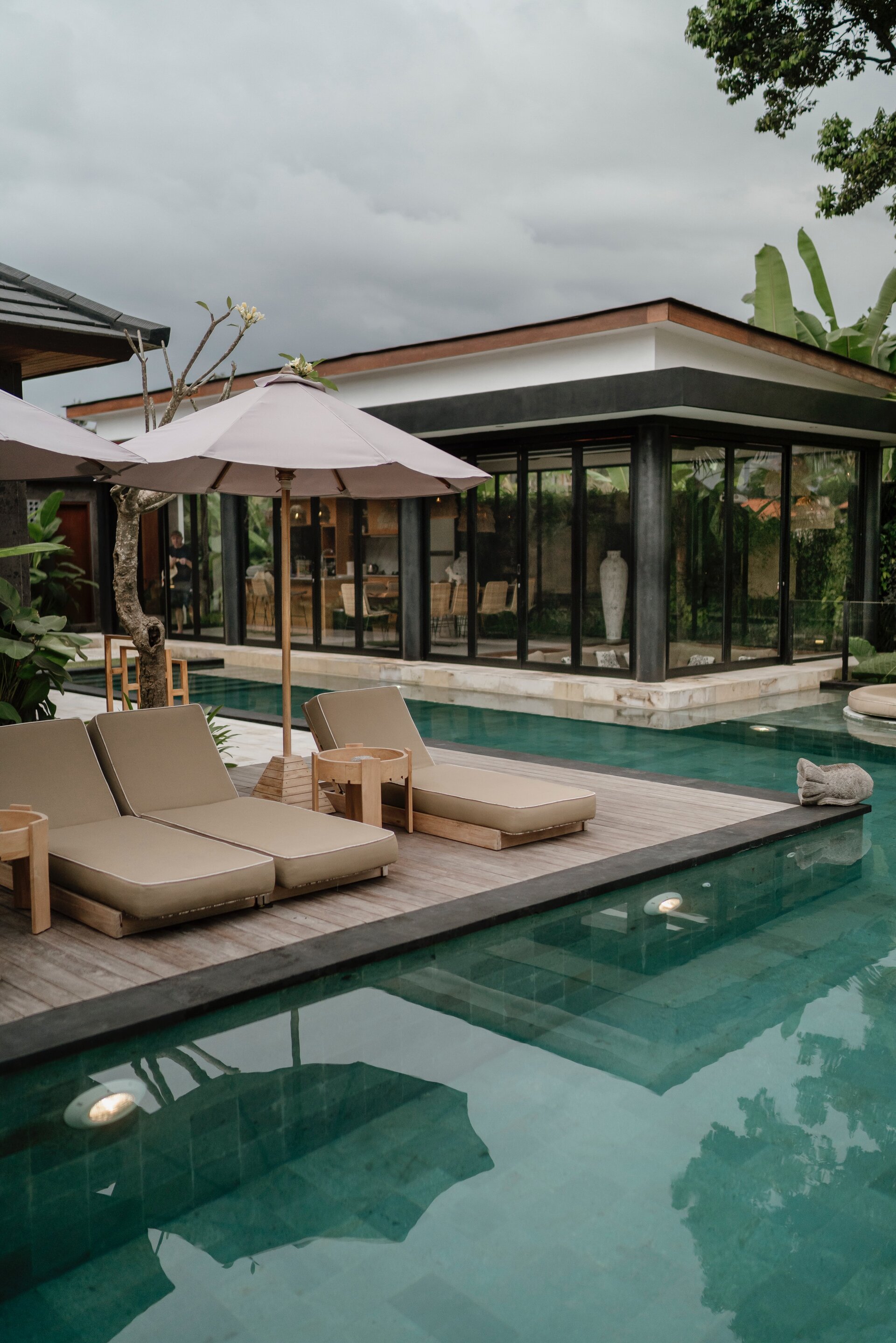 Pool villa with deck chairs and umbrella